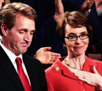 Flake talks to Giffords before U.S. President Barack Obama delivered his State of the Union address on January 24, 2012 in Washington, DC. / Brendan Smialowski/Getty