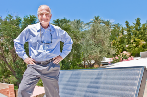 Former U.S. Rep. Barry Goldwater Jr., a strong supporter of solar energy, in front of the solar energy panel on his home's roof. / Photo by Evan Wyloge:Arizona Capitol Times