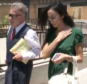 Alejandra Amarilla Menrath walks with her attorney at the courthouse. / 12 News