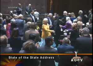 Gov. Brewer shakes hands with lawmakers as she leaves the House after her State of the State address.