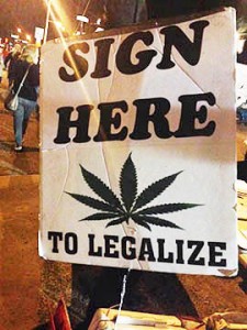 A sign seeks signatures on a petition to have a referendum in November on legalizing the recreational use of marijuana in Arizona. / Photo by Moriah Costa