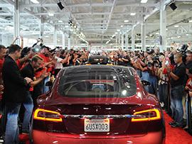 A Tesla drives down the red carpet at the company’s factory in Fremont, California, in June 2002. / Flickr 