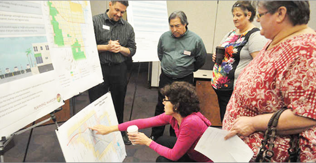 Maricopa resident looks over the transportation portion of the draft General Plan while planner Ryan Wozniak (from left), transportation manager David Maestas and Tortosa residents Liz and Anita Cecini /inMaricopa
