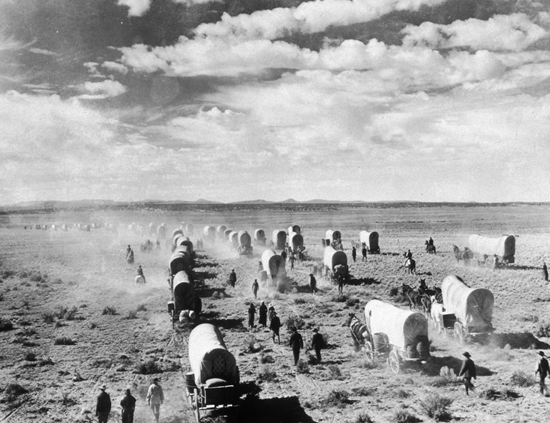 A wagon train of American homesteaders moves westward across the open plains, circa 1885. /Credit American Stock:Getty Image
