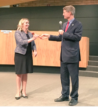 Mayor John Lewis passes the gavel to council-appointed Jenn Daniels./Twitter