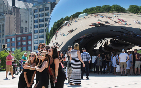 A group of millennials take a selfie in front of Cloud Gate, commonly known as “The Bean,” in downtown Chicago. /Elizabeth Campbell/News21