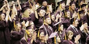  Arizona State University students celebrate in this spring 2006 graduation photo. A new report said 2014 college graduates from Arizona had some of the lowest student debt rates in the nation. /Photo: Tom Story/ASU 